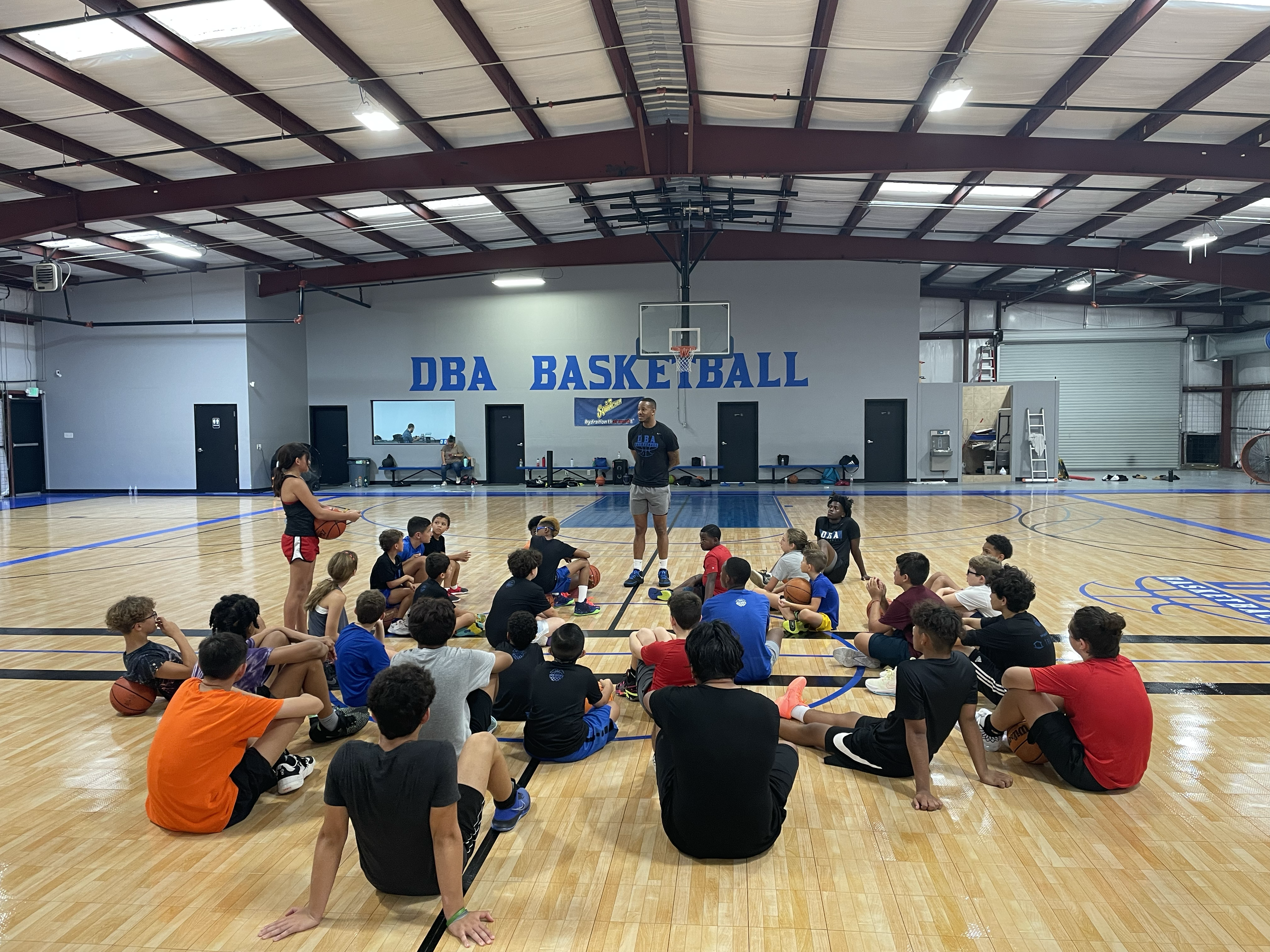 DBA coach instructing players during skill clinic